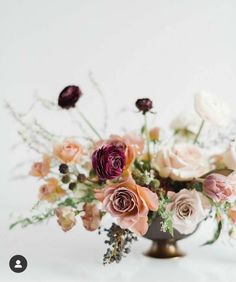 a vase filled with lots of different colored flowers