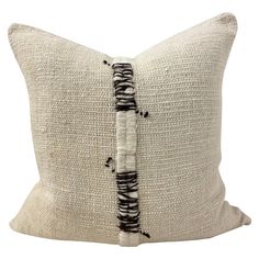 a black and white pillow with fringes on it