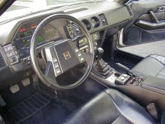 the interior of a car with black leather seats and dash board, steering wheel and dashboard