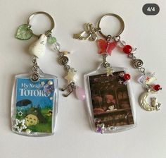 two key chains with pictures and charms attached to them