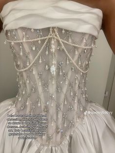 the back of a wedding dress with pearls on it