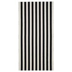 a black and white rug with vertical stripes