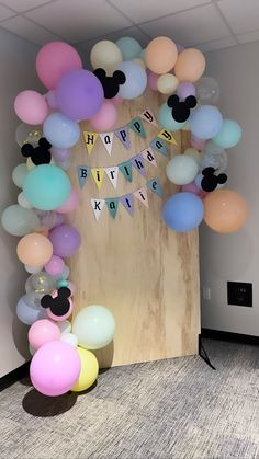 balloons and streamers decorate the entrance to a mickey mouse themed birthday party