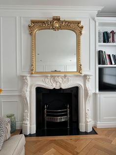 a living room with a fire place and a mirror on the fireplace mantels