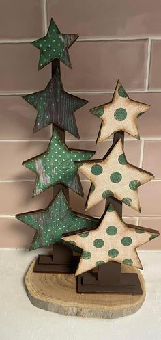 three wooden christmas trees sitting on top of a table