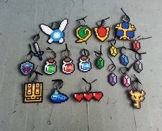 a collection of pixel keychains with various designs and colors, all in different shapes and sizes