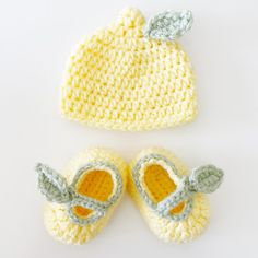 two crocheted baby shoes and a knitted hat