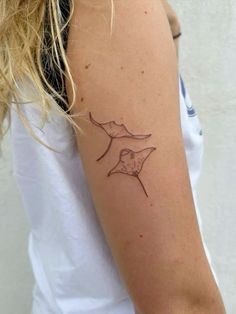 a woman with a small tattoo on her arm