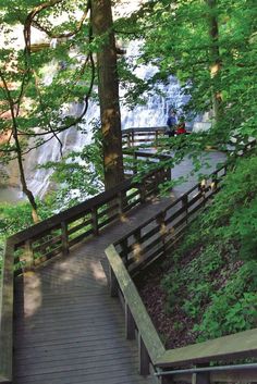 stairs leading up to a waterfall in the woods with a sign that reads hikes under 5 miles in ohio