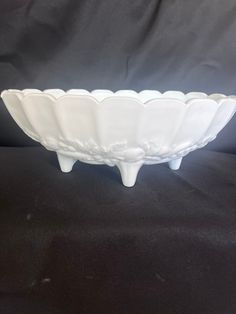 a white bowl sitting on top of a black table