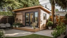 a small wooden shed with patio and seating area