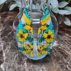 Shop ascsbeauty1's closet or find the perfect look from millions of stylists. Fast shipping and buyer protection. These beautiful YELLOW FLOWER fringe earrings were beaded by me using Japanese Delica Beads in the colors Canary Yellow, Topez, Rootbeer, Blue Turquoise, Dark Green Rainbow and Coral Luster. They measure approximately 4" in length and 1.25 in width. I hope you enjoy wearing them as much as I had making them. Yellow Beaded Earrings With Ear Wire For Summer, Yellow Dangling Beads Earrings For Summer, Summer Yellow Beaded Earrings With Ear Wire, Summer Yellow Dangling Beads Earrings, Yellow Summer Earrings With Dangling Beads, Yellow Summer Jewelry With Dangling Beads, Summer Yellow Earrings With Dangling Beads, Bohemian Yellow Beaded Dangle Earrings, Summer Yellow Jewelry With Dangling Beads