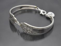 "♥*'¨) ¸.*¸.*'¸.**'¨) ¸. (¸.*' (¸.*` This bracelet was made out of 2 vintage silver plated spoons. The name of this spoon pattern is called 1941 Precious. Sizing is adjustable from 5\" to an 9\" wrist with lobster clasp. Ships in a ready to give gift bag. Special orders always welcome. We can make jewelry, coat hooks or windchimes with your silverware too! Shipping Info: To save on shipping, purchase multiple items from my shop at one time and they will ship together with a reduced shipping cost Nickel-free Antique Silver Sterling Bracelet As A Gift, Spoon Pattern, Vintage Nickel-free Sterling Silver Bracelet In Antique Silver, Vintage Sterling Silver Nickel-free Cuff Bracelet, Nickel-free Antique Silver Sterling Silver Charm Bracelet, Antique Nickel-free Charm Bracelet Collectible, Silverware Jewelry, Make Jewelry, Coat Hooks