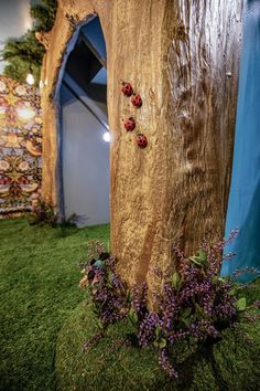 a wooden sculpture with ladybugs on it