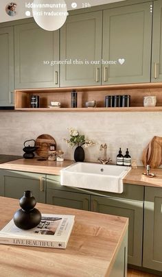 a kitchen with green cabinets and wooden counter tops is featured in the ad for independent living magazine