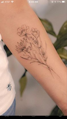 a woman's arm with flowers on it