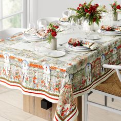 the table is set for christmas dinner with plates and silverware on it's placemats