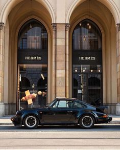 a black car parked in front of a building