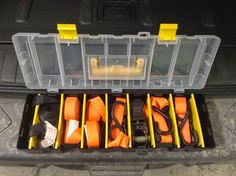 an open tool box filled with orange and black tools