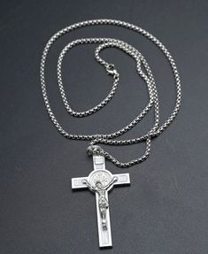 "Silver-toned necklace that has a round shape chain made from stainless steel.  The crucifix is 2\" silver-toned with white enamel. Be protected while you wear the Saint Benedict crucifix.  Other rosaries in my store https://faithfulproductsus.etsy.com" White Stainless Steel Cross Pendant Necklace, Sterling Silver Crucifix Necklace With Silver Chain, Stainless Steel Crucifix Necklace With Silver Chain, Silver Crucifix Cross Necklace With Chain, Luxury Silver Crucifix Necklace, Adjustable Nickel-free Crucifix Necklace, Nickel-free Stainless Steel Crucifix Necklaces, Nickel-free Sterling Silver Crucifix Jewelry, Saint Benedict