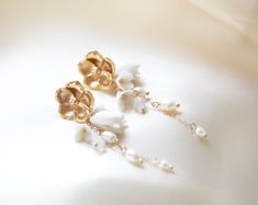 Make a statement on your special day with our gorgeous CALLIE Freshwater Pearl Floral Earrings! Perfect for any modern bride, they combine golden tones with glimmering pearl accents to create an exquisite flowery design. A must-have accessory to complete your look! - PLEASE ALLOW APPROX 10 BUSINESS DAYS FOR COMPLETION BEFORE SHIPPING. - Handcrafted with genuine freshwater pearls and Austrian crystals- Created in my studio in PA- White opal crystals- Freshwater pearls- Polymer clay flowers- Yello Feminine Yellow Gold Wedding Earrings, Gold Pearl Drop Bridal Earrings, Feminine Gold Bridal Earrings For Formal Occasions, Delicate Yellow Gold Bridal Earrings For Wedding, Yellow Gold Elegant Chandelier Earrings For Wedding, Delicate Pearl Charm Flower Earrings For Wedding, Gold Pearl Flower Bridal Earrings, Feminine Gold Pearl Earrings For Wedding, White Gold Plated Chandelier Earrings With Pearl Drop