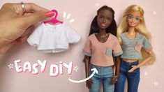 a hand is holding a barbie doll next to two other dolls with clothes on them