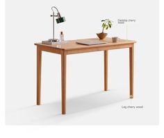 a wooden table with some plants on it and an electronic device sitting on top of it