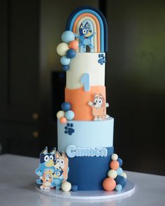 a three tiered cake with cartoon characters on it