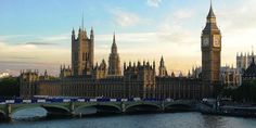 the big ben clock tower towering over the city of london, england as seen from across the river thames