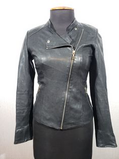 Cute women's leather jacket with a metal zipper. Women's black leather biker jacket. The jacket is made of strong, soft black genuine leather. The jacket is easily fastened with a metal zipper. At the bottom of the jacket there are two pockets that close with a metal zipper. The jacket has a collar stand that fastens with a metal snap. The jacket has a decorative zipper on the back. The jacket has a nice polyester lining. The jacket is light and pleasant to the touch. An elegant cut with aggressive elements will emphasize your independence and confidence. MEASUREMENTS Jacket length                55 cm  |  21.5 in Pit to pit                        45 cm  |  17.5 in Chest  circumference    90 cm  |  35.5 in                                                            Waist circumference     8 Amy Brown, Black Leather Biker Jacket, Leather Biker Jacket, Leather Jackets Women, Cute Woman, Soft Black, Biker Jacket, Leather Women, Black Leather