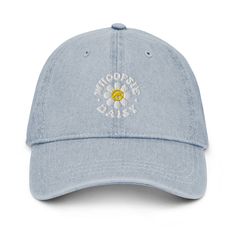 a light blue hat with the words, photographer's dream on it and an embroidered daisy