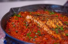 a pan filled with meat and sauce on top of a stove