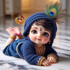 a baby doll is laying on the floor wearing a blue outfit with a peacock feather on it's head