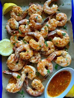 the shrimp is ready to be served with dipping sauce and lemon wedges on the side