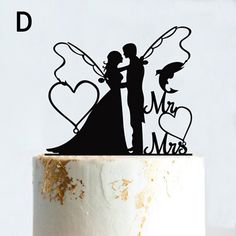 a wedding cake topper with the silhouette of a bride and groom holding each other