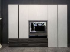 an entertainment center with white cabinets and black accents