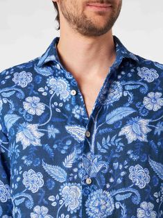 Man Pamplona shirtFlower print on blue backgroundRegular fitLong sleevesClassic necklineFront closureButtoned cuffsComposition: 100% Linen Elegant Shirt With Floral Print And Spread Collar, Blue Shirt With Spread Collar For Spring, Spring Blue Shirt With Spread Collar, Blue Spread Collar Blouse For Summer, Summer Blue Blouse With Spread Collar, Blue Floral Print Long Sleeve Shirt, Indigo Floral Print Tops For Summer, Summer Floral Print Indigo Top, Spring Blue Floral Print Shirt