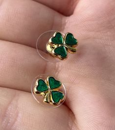 These beautifully finished Gold plated earrings are presented with a shamrock design. The emerald green enamel three leaf shamrock brings these dainty stud earrings to life with a bit of Irish luck! These Celtic earrings are a symbol of Ireland and a beautiful fashion accessory for any occasion! - Gold plated - Enamel three leaf shamrock at center - Made in Ireland - Comes in a branded gift pouch - Great gift for her Hypoallergenic Green Enamel Jewelry, Shamrock Design, Irish Luck, Shamrock Earrings, Celtic Earrings, Dainty Studs, Earrings Dainty, Gift Pouch, Enamel Earrings