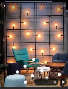 an image of a living room setting with lights on the wall and furniture around it