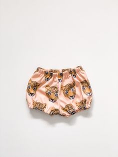 Your little girl will look so stylish in these adorable bloomers, and they are super comfy to boot. Pair these with the coordinating peplum tank for an outfit your little lady will love!. These stylish bloomers feature 100% organic cotton knit produced in the USA that is certified organic by global organic textile standards so you can feel good about dressing your baby in these day after day! We serge all seams for added durability and strength and use high quality braided elastic for the waistb Cute Pink Short Bloomers, Cute Short Pink Bloomers, Cute Pink Bloomers With Elastic Waistband, Playful Pink Bloomers With Elastic Waistband, Summer Playful Diaper Cover With Elastic Waistband, Playful Summer Diaper Cover With Elastic Waistband, Cute Pink Bloomers For Playwear, Summer Diaper Cover With Elastic Waistband, Cute Shorts With Elastic Waistband For Playwear