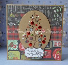 a handmade christmas card with a tree on the front and red, green, white, and blue buttons