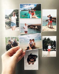 a person holding up several polaroid photos in front of a stainless steel refrigerator freezer