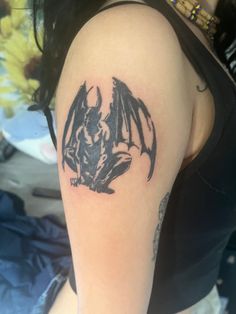 a woman with a bat tattoo on her arm