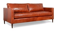 a brown leather couch sitting on top of a white floor