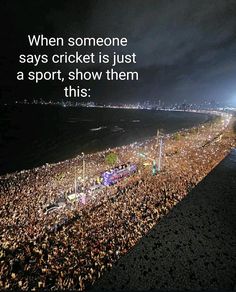 a large crowd is gathered at the beach to watch an event with lights in the dark