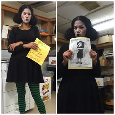 two women in black dresses holding signs and posing for the camera with their mouths open