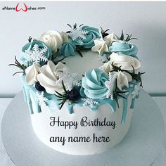 a birthday cake decorated with blue and white flowers