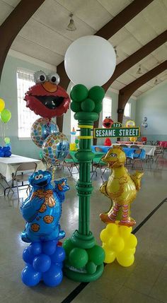 some balloons that are on top of a lamp post in the middle of a room