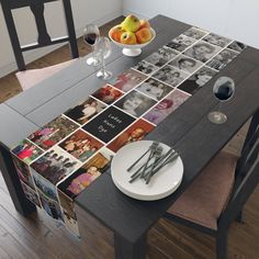 a dining room table with pictures on the table and place settings for wine glasses, fruit and utensils