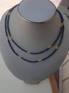 "Lapis fact rondelle 4mm beaded necklace 40\". with golden pyrite beads and silver spring clasps with gold polish. semiprecious beads color: blue and golden. beautiful ready to wear." Gold Lapis Lazuli Necklace With Faceted Beads, Gold Lapis Lazuli Faceted Beads Necklace, Gold Double Strand Polished Beads, Gold Polished Double Strand Beads, Gold Gemstone Beaded Rondelle Necklaces, Gold Rondelle Beaded Necklaces With Gemstone Beads, Gold Rondelle Gemstone Beaded Necklace, Gold Rondelle Beaded Necklace With Gemstone Beads, Black Pearl Jewelry